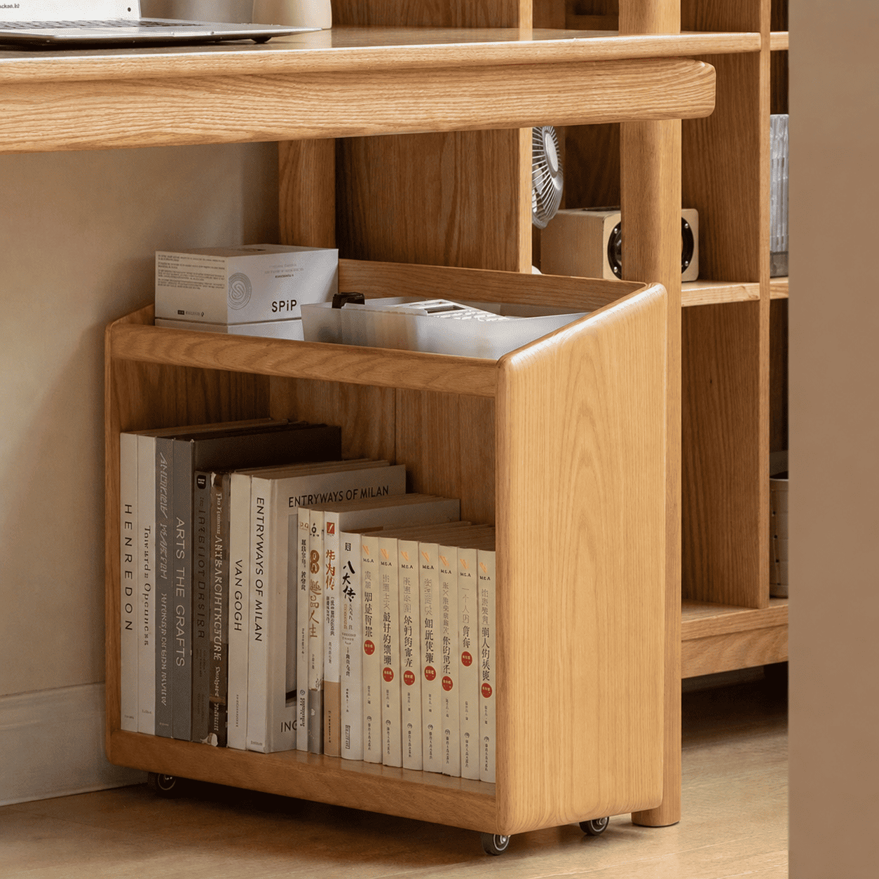 Natural oak mobile book storage cabinet with open compartments and concealed caster wheels.