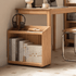Mobile wooden storage unit with open shelves and caster wheels for flexible home organisation.