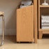 Rolling oak storage cabinet with open shelving for books, magazines, and everyday essentials.