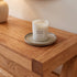 Natural oak hallway table styled with lamp, vase, books, and indoor plants