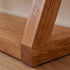 Zetland Natural Solid Oak Console Table styled with round mirror, table lamp, plants, and books in a modern living room