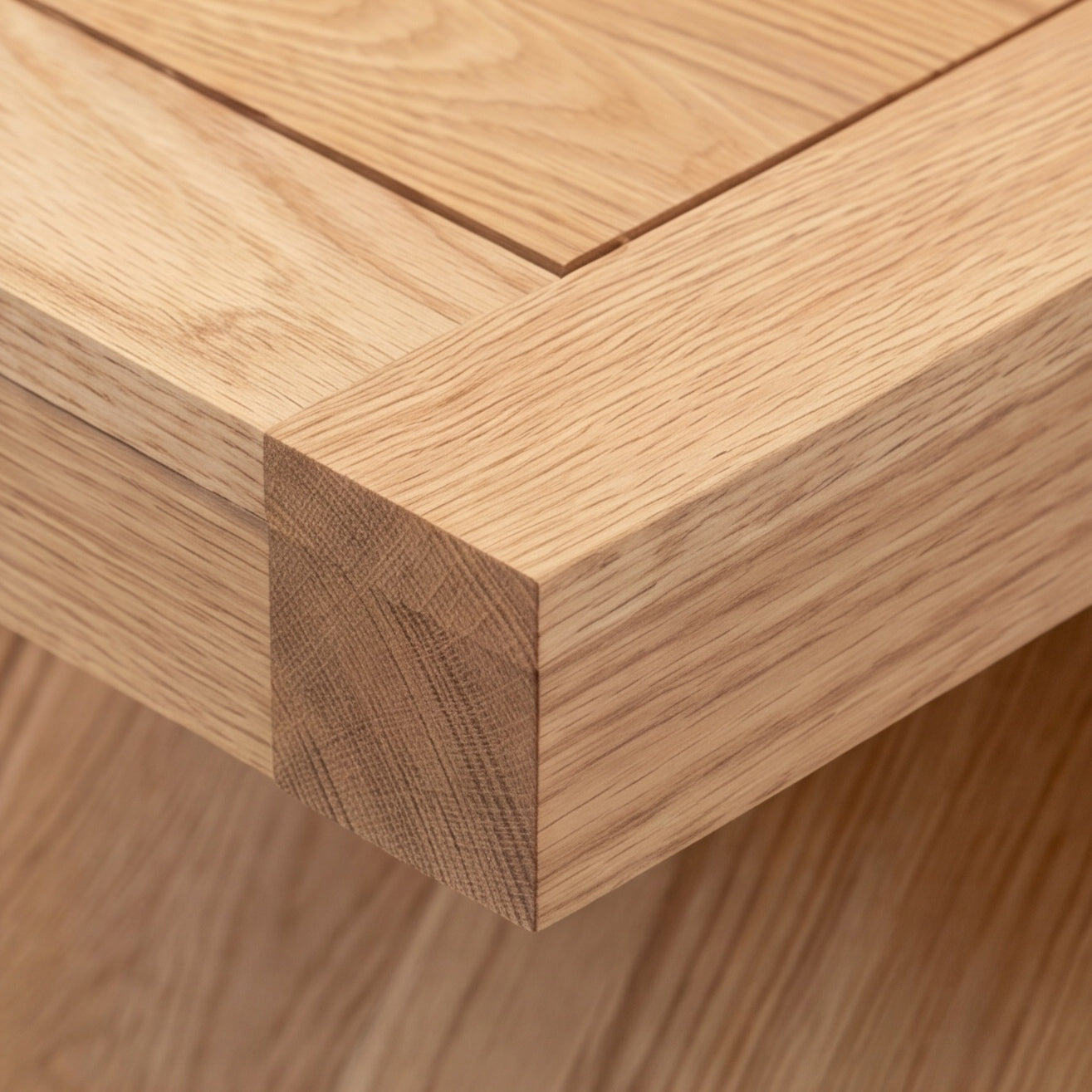 Solid oak side table styled with table lamp, coffee mug, and open magazine