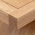 Solid oak side table styled with table lamp, coffee mug, and open magazine