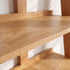 Large solid oak bookcase styled with books, framed prints, vases, and indoor plants