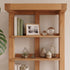 Zetland large oak bookcase styled with woven baskets for practical home storage
