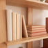 Warm solid oak bookshelf with natural grain finish for books, décor, and indoor plants