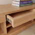 Natural solid oak entertainment unit with open media shelves and warm wood grain finish