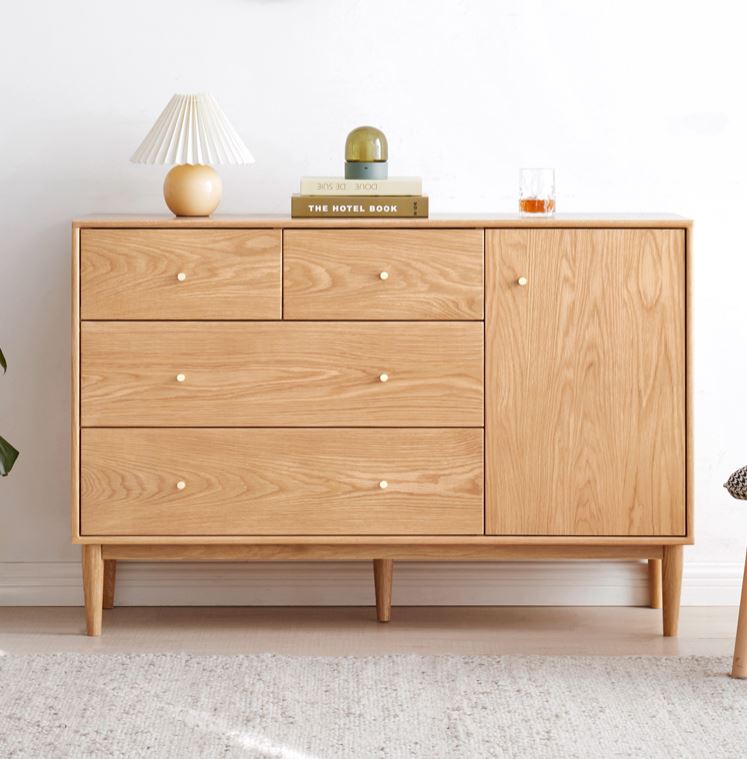 a wooden dresser with a lamp on top of it